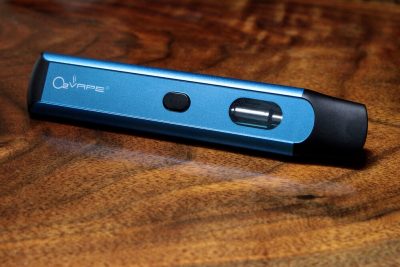 The Option Disposable Vape pen is horizontally displayed across this image, with the base on the left and black mouthpiece on the right. The body is blue with the O2VAPE logo visible at the base, and a black button in the center. Towards the mouthpiece is the liquid chamber.
