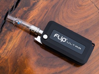 O2VAPE FLIP® ULTRA Vape Pen in a sleek, rectangular design with a matte black finish and branding ‘FLIP® ULTRA’ visible on the body. The device is open, showcasing its unique flip mechanism that conceals the cartridge.